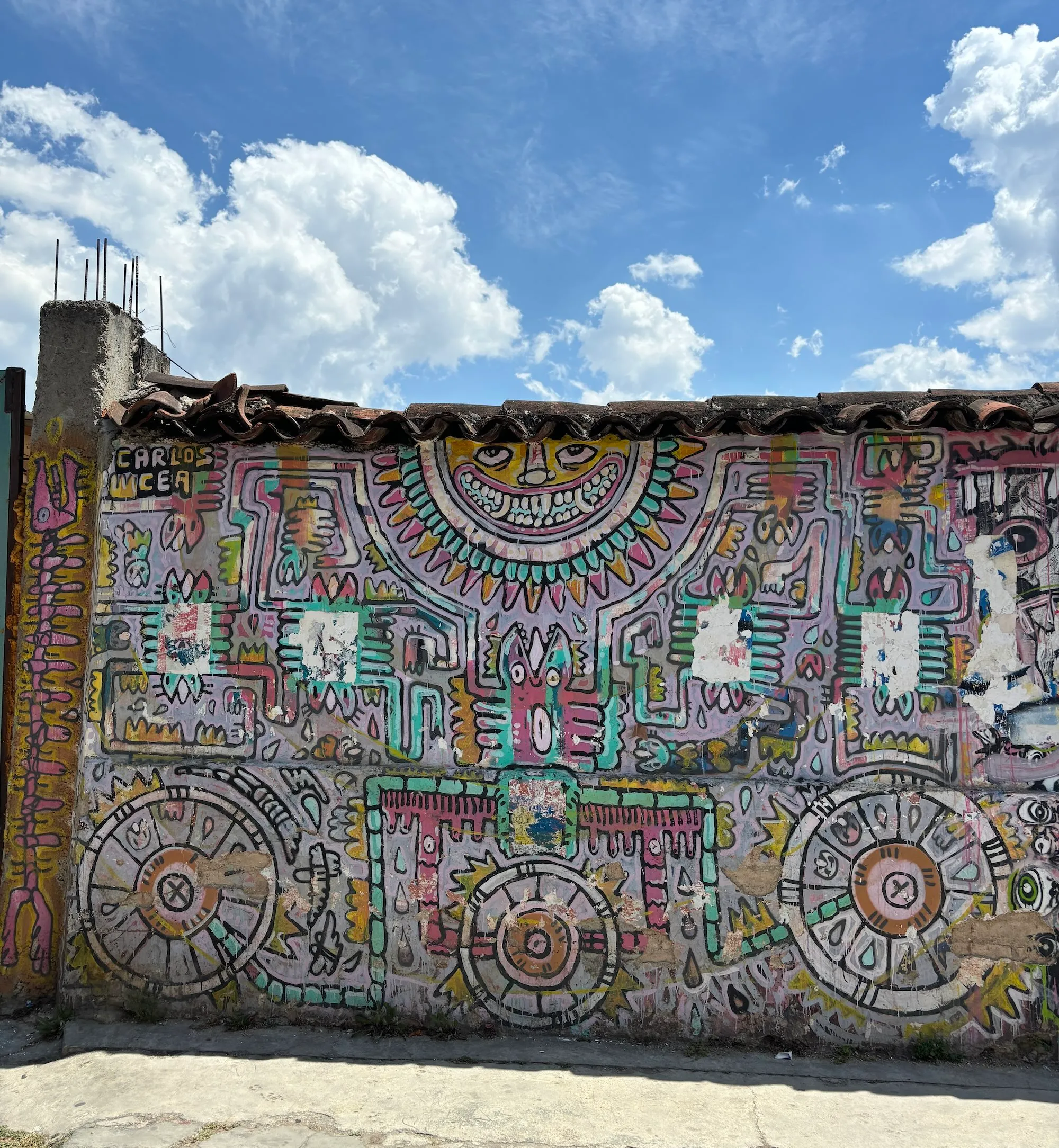 Colorful mural under a bright blue sky.